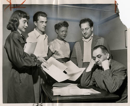 Stanley S. Jados (right), assistant professor of political science at DePaul, wears a worried look as pupils in his class (left to right) Florence Wrzesien, Jim Lambert, Elizabeth Hicklin and Stanley Provenzano turn in ratings on his classroom efficiency. (Daily News photo). May 21, 1949. (Image courtesy of DePaul University Special Collections and Archives)